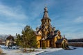 Wooden Russian church in sunny winter day Royalty Free Stock Photo