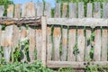 Homemade hedge of old wooden boards in the village Royalty Free Stock Photo