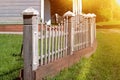 Wooden rustic fence in village near the house near the forest. Authentic traditional culture in architecture and life. Sunlight