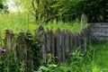 Wooden rustic fence in village near the house near the forest. Authentic traditional culture in architecture and life. Sunlight,