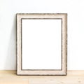 Wooden rustic picture frame standing on a table. Product mock up