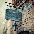 Wooden rustic signboard on aged medieval wall Royalty Free Stock Photo