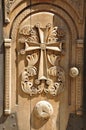 Wooden sacral door with cross carved on it. Royalty Free Stock Photo
