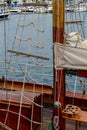 Wooden sailboat on the blue mediterranean sea Details of a classic beautiful sailing yacht with ropes knots and wood plank on deck Royalty Free Stock Photo