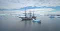 Wooden sailing yacht travel in Antarctica, aerial Royalty Free Stock Photo