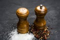 Wooden salt shaker and pepperbox on black chalk board. Royalty Free Stock Photo
