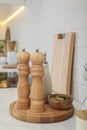 Wooden salt and pepper shakers, bowl with bay leaves on white countertop in kitchen Royalty Free Stock Photo