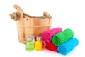 Wooden sauna bucket with colorful towels and soap Royalty Free Stock Photo