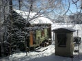 A wooden sauna house and a small smokehouse in winter Royalty Free Stock Photo