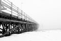 Wooden scary bridge disappearing in the fog. Bridge leading to nowhere.