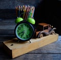 Wooden school pencil case, alarm clock, color pencils, wooden typewriter on an old wooden table. Royalty Free Stock Photo