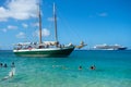 A wooden schooner anchored off a pristine beach on christmas day