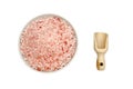 Wooden scoop, bowl full of bath salts with pink and white grains Royalty Free Stock Photo