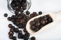 Wooden scoop with dried juniper berries Royalty Free Stock Photo