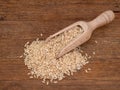Wooden scoop with long grain brown rice on rustic wooden board. With copyspace. Royalty Free Stock Photo