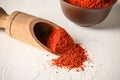 Wooden scoop with paprika powder on table Royalty Free Stock Photo