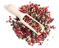 Wooden scoop on pile of Four Pepper Blend on white