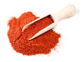 Wooden scoop on pile of paprika powder on white Royalty Free Stock Photo