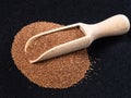 Wooden scoop on wholegrain teff seeds on black Royalty Free Stock Photo