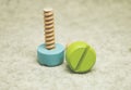 Wooden screws on a beige background children`s toy decor item repair detail tool Royalty Free Stock Photo