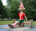 Wooden sculpture of Buratino (Russian Pinocchio) in the park Royalty Free Stock Photo