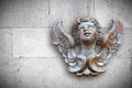 Wooden sculpture of an italian angel against a stone wall Royalty Free Stock Photo