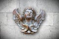 Wooden sculpture of an italian angel against a stone wall Royalty Free Stock Photo