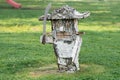 a wooden sculpture of the Nutcracker handmade from birch on a background of grass