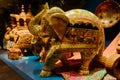 Wooden sculptures of elephant on table in display window