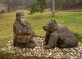 Wooden sculptures of an old man and a bear