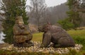 Wooden sculptures of an old man and a bear