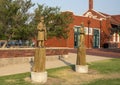 Wooden sculptures of 1890s-like railroad workers by chainsaw artist Clayton Coss at Norman Depot in Norman, Oklahoma.