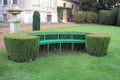 Wooden seat or bench with a sculptured hedge