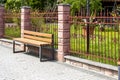 wooden seats along the metal fence