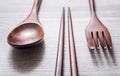 Wooden Set Of Chopsticks, Fork And Knife Lying Parallel To Each Other, High Angle View Royalty Free Stock Photo