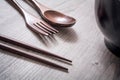 Wooden Set Of Fork, Knife And Chopsticks Next To A Bowl On A Table - Eating Chinese Food Concept Royalty Free Stock Photo