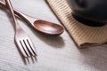 Wooden Set Of Fork And Knife Next To A Bowl With Napkin On A Table, High Angle View Royalty Free Stock Photo
