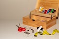 A wooden sewing kit on a white table with many accessories. Perfect for haberdashery