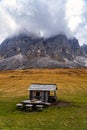 Wooden shed on a grassy meadow in a mountains Royalty Free Stock Photo