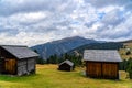 Wooden shed on a grassy meadow in a mountains Royalty Free Stock Photo