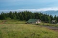Wooden  shed  in Jeseniky mountains on a summer foggy morning and  sea of clouds around mountain peak Royalty Free Stock Photo
