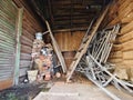 Wooden shed with metal trash on a rustic lot