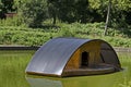 Wooden shed for sheltering birds in the water of a small lake Royalty Free Stock Photo