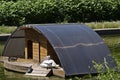 Wooden shed for sheltering birds in the water of a small lake Royalty Free Stock Photo