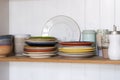 Wooden shelf with kitchen utensils, rustic style. Tableware, plates and bowls stand on a shelf in the kitchen. Cupboard with set Royalty Free Stock Photo