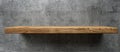 Wooden shelf mounted on concrete wall using wood stain for a natural finish Royalty Free Stock Photo