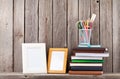 Wooden shelf with photo frames, books and supplies Royalty Free Stock Photo