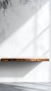 Wooden Shelf on White Concrete Wall with Light Shadows Mockup Display Royalty Free Stock Photo