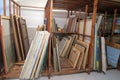 Wooden shelves at art gallery storage full of pictures