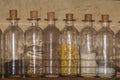 wooden shelving with glass bottles with spices inside Royalty Free Stock Photo